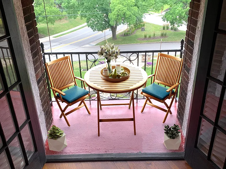 Private balcony with awning and exterior light.