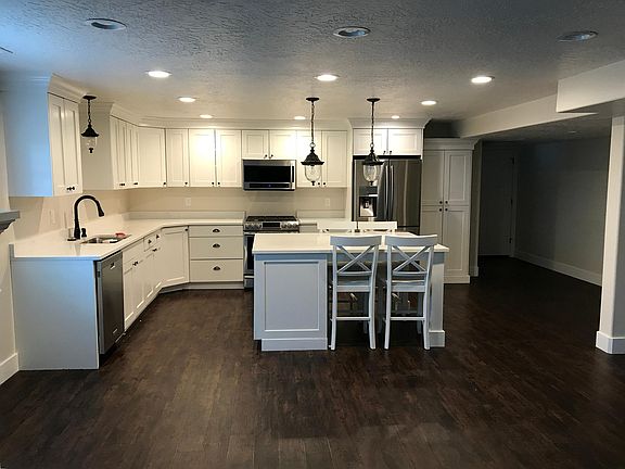 Large gourmet kitchen with lots of cupboard and counter space. Newer Samsung Stainless steal appliances including convection oven, built in table/island with countertops.