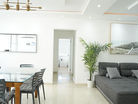 Glass dining table adjacent to living space