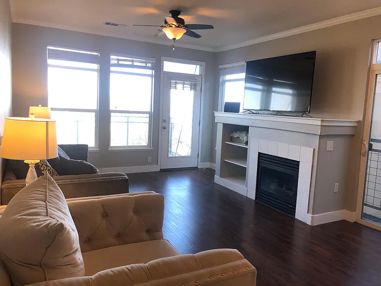 SO many windows! This corner unit gets SO much natural light during the daytime! Features a fireplace and mountain views! The door featured in this photo faces West and leads to the balcony