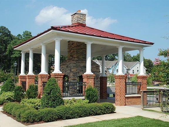 Community waterside pavilion with fireplace and deck seating.