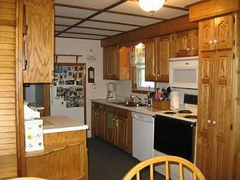 Kitchen with newer oak cabinets, electric range, refrigerator, dishwasher & disposal