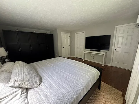 primary bedroom w/ wardrobe.