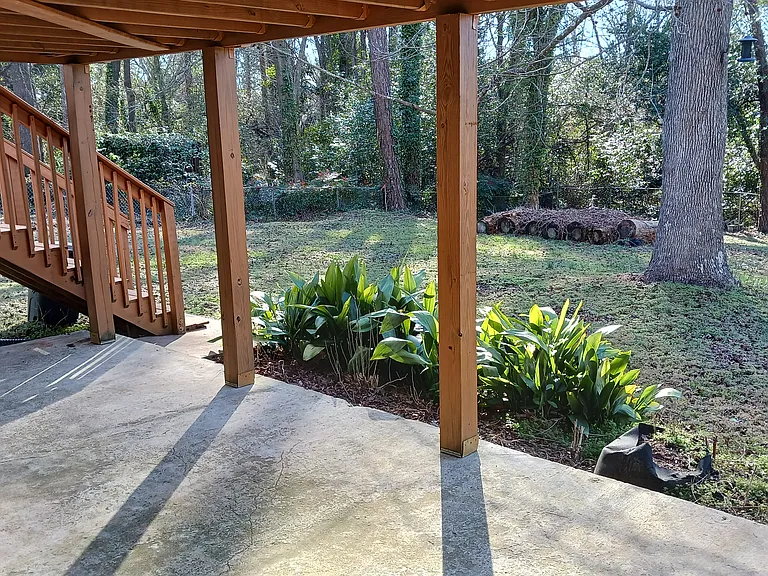 Patio underneath deck for basement apartment