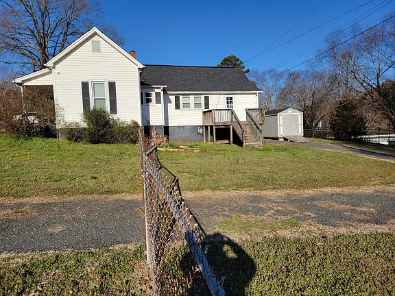 Side of House & Rear Fenced entry & storage shed