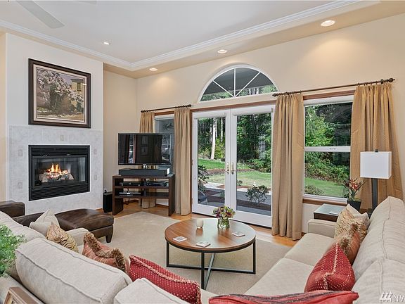 Cozy up to the fireplace and enjoy the peaceful and private backyard views