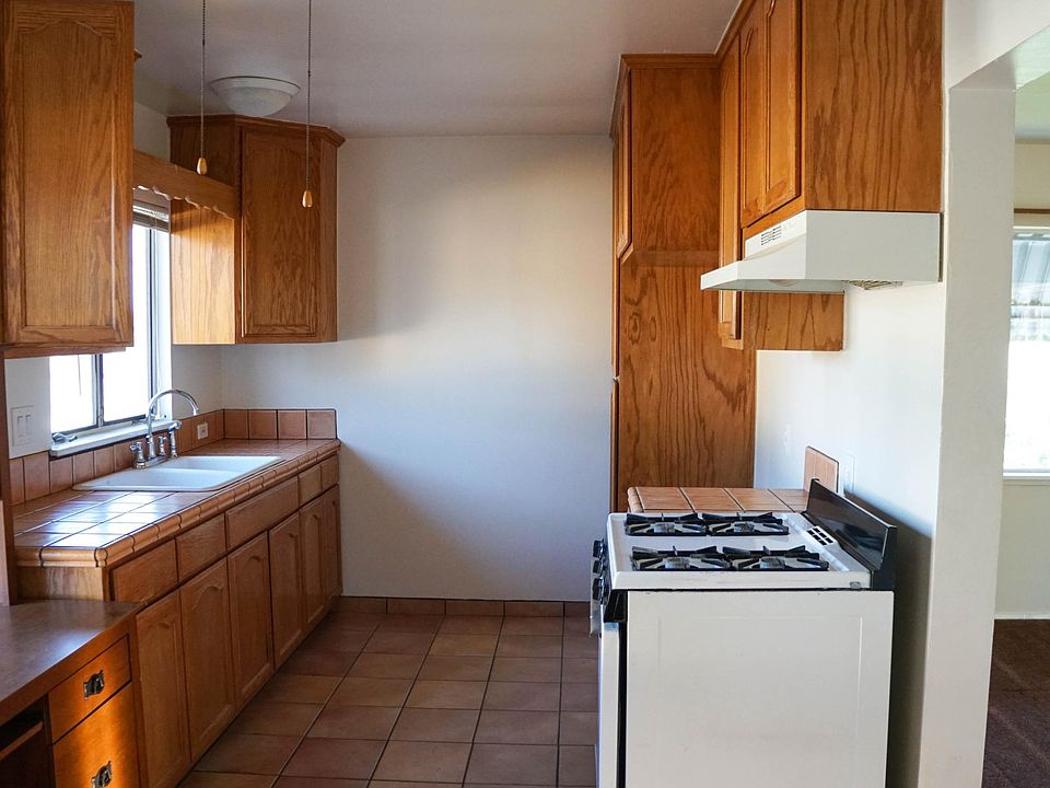 Kitchen with Storage Cabinets, Stove and Ceiling Fan