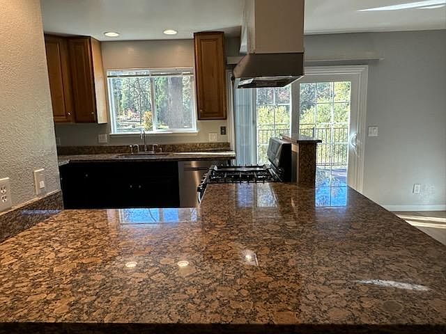 Custom kitchen with granite countertops and plenty of space for barstools