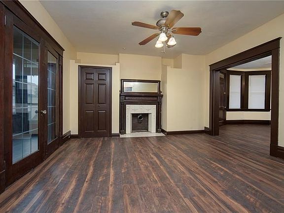 LIVING ROOM - An overall view of the formal living room highlighting the grand decorator fireplace and its beautiful floors. The