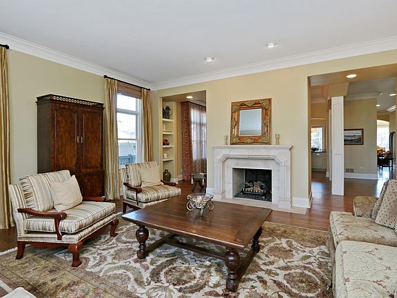 Living room offers a gas fireplace with a custom surround.