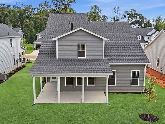 Superior curb appeal continues to the back with a refined, covered outdoor living space