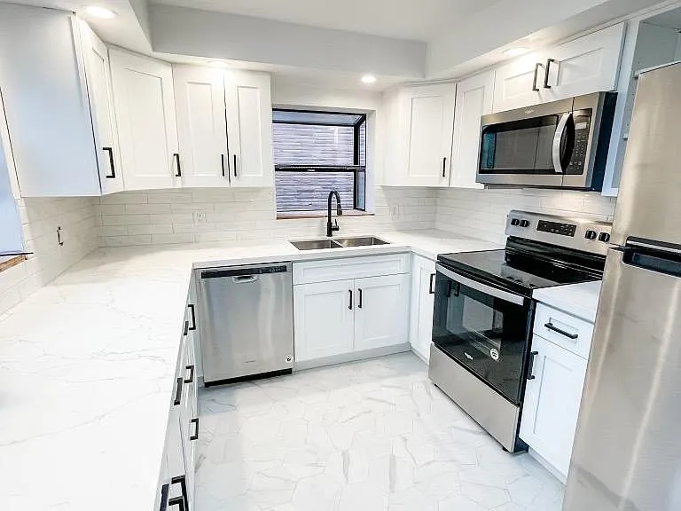 Newly remodeled kitchen! Bright and light with 2 windows and a skylight. View empty.