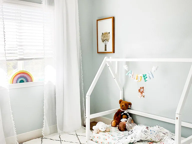 Sweet little nursery painted in a soft, "lullaby blue" color with plenty of natural light!