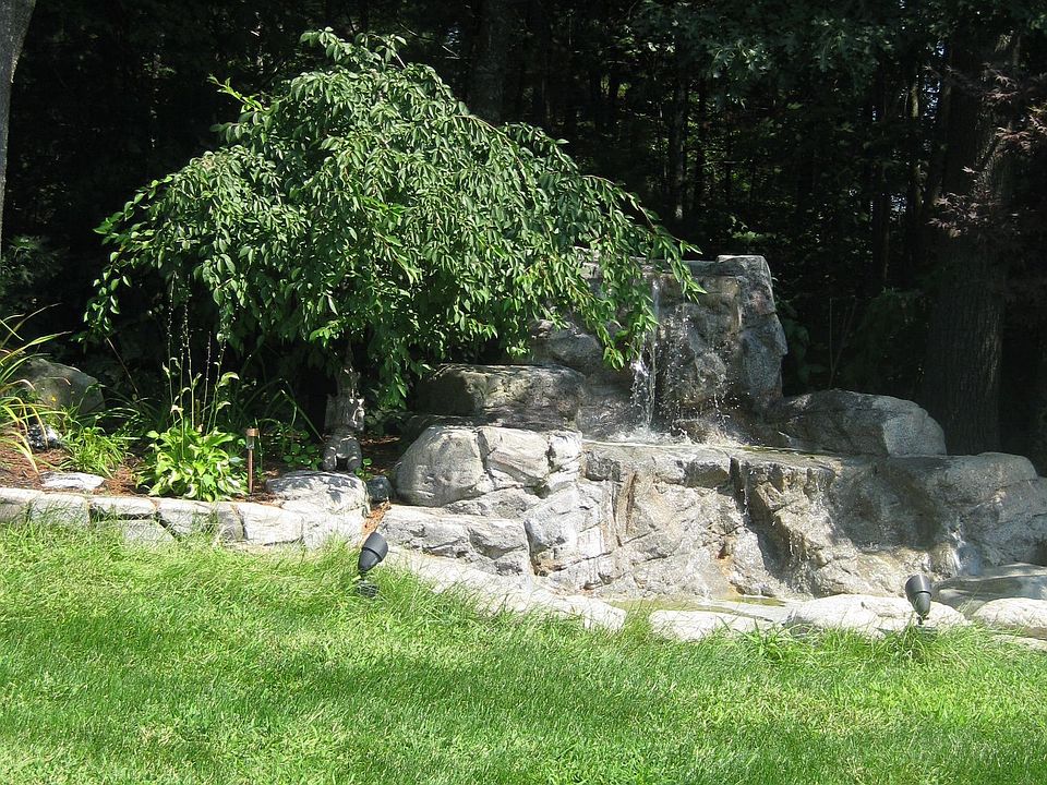 Professionally landscaped with Retaining Rock Walls, Irrigation and Waterfall