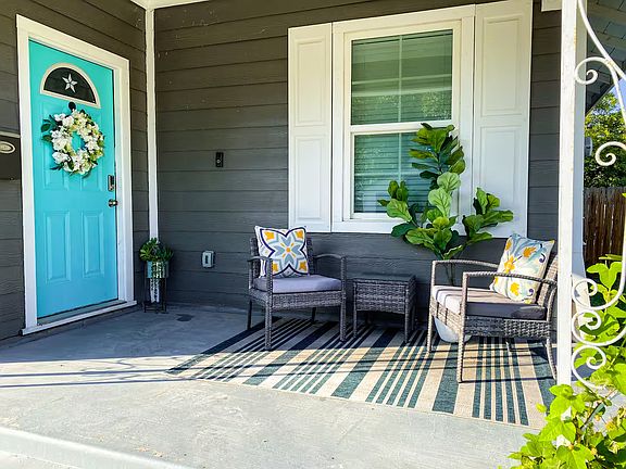 Sip your morning coffee, unwind with a good book, or simply relax on this welcoming front porch designed for peaceful outdoor living.