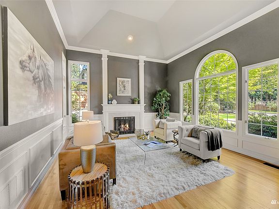 Front room has high ceilings and a cozy gas fireplace.>