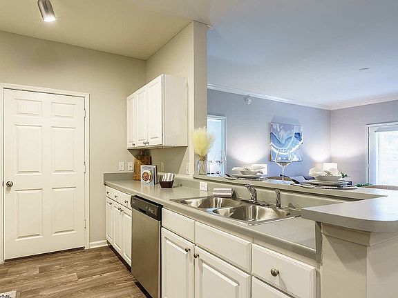 Experience the seamless blend of a modern kitchen and cozy living space.