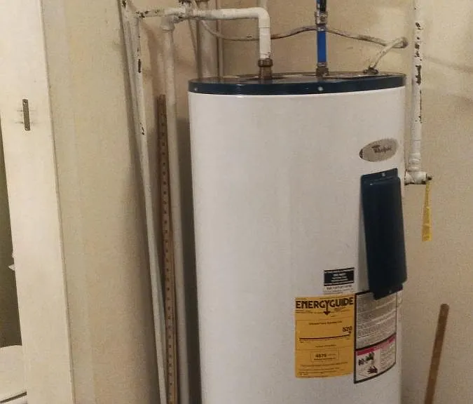 Walk-in laundry with a stackable washer and dryer + storage space.