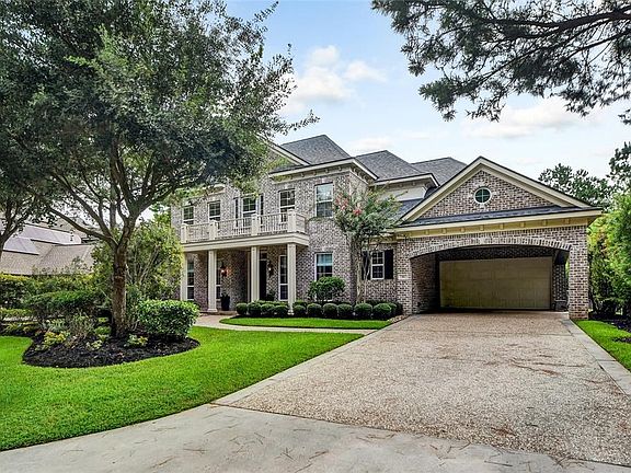 Mahogany double doors lead into entry with soaring ceiling, trimmed archways and beautiful hardwoods.