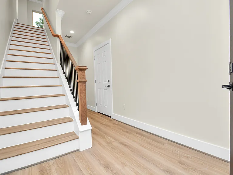 1st floor entry leading to bedroom, garage and stairwell