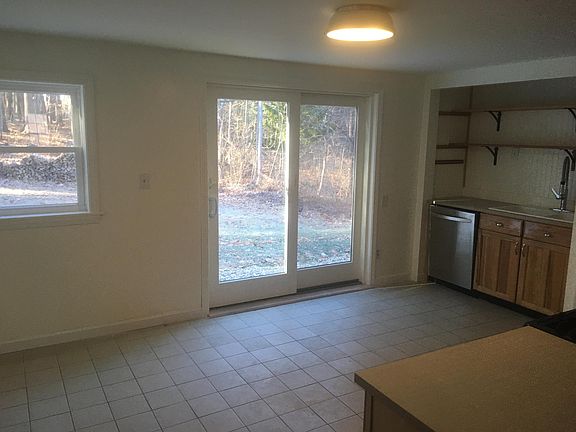 Kitchen view looking out the slider door to the back yard.