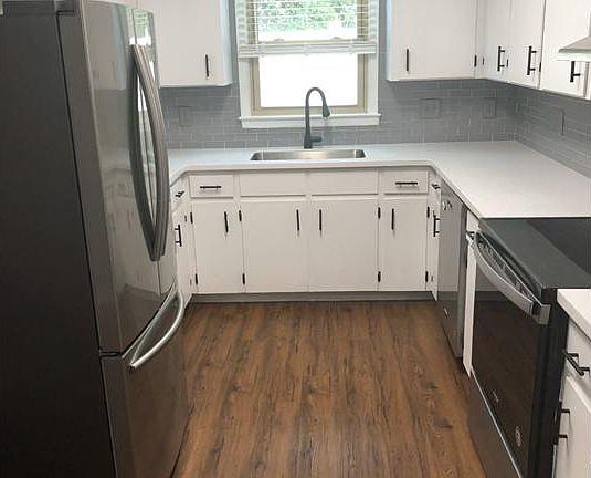 Kitchen with new stainless steel appliances, undermount sink, and new fixtures.