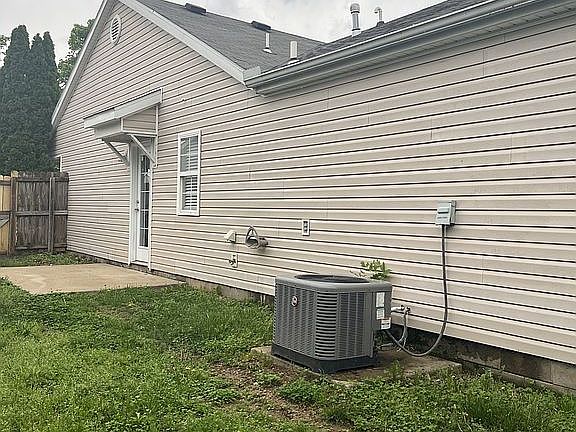 Side with open patio, fenced