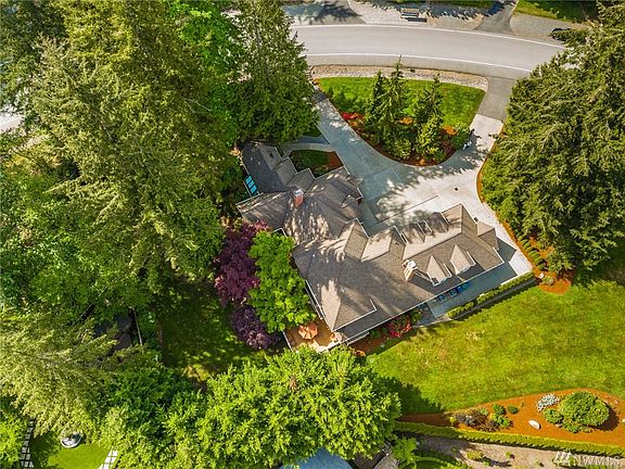 Circular drive, extra parking spaces, fully fenced backyard and expansive grassy emerald lawns.