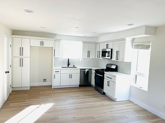 Beautiful kitchen with plenty of storage and stainless steel stove, dishwasher, and microwave