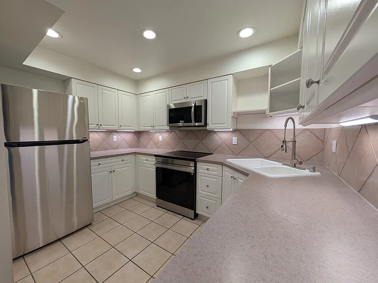 Kitchen with new induction range, new microwave, new fridge.