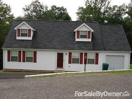 Front of house - side angle view
						:
						Front of house, garage, driveway and front walk