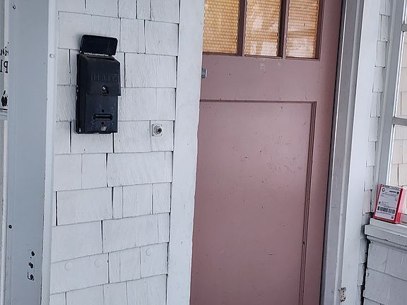 Separate entrance off a porch shared with main floor tenant.