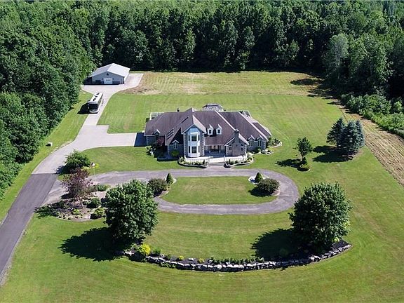 This Home has it all! Drive up to the Pole Barn/Man Cave, circle around the front of the house and enter through the magnificent entryway or pull into the 2.5 car side loading garage