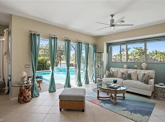Generous Family-Room surrounded by bright western-sunset window light and extraordinary blue sky, tropical views