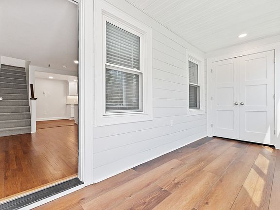 Entry from three season sun porch with large cedar closet.