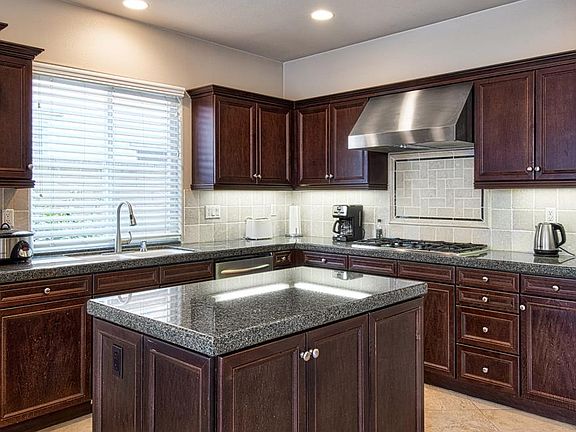 Kitchen with stainless steel appliances and granite counters