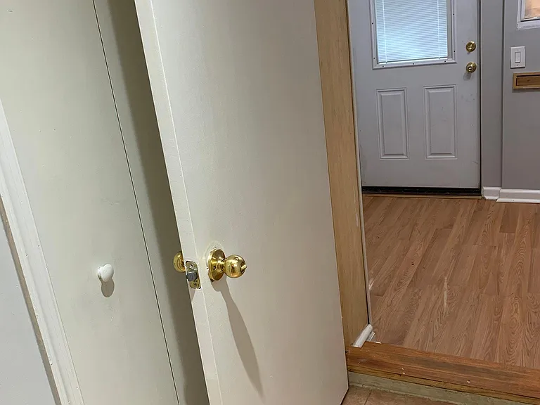 Looking towards one of two exterior doors . That's the smaller room /study