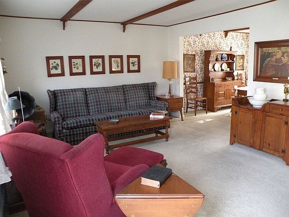 Living Room open to Dining Room w/Beamed Ceiling & Hardwood under w/w Carpet