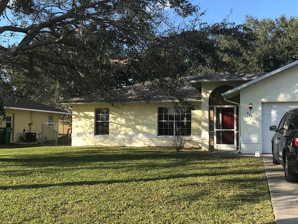 Large oak tree & queen palms