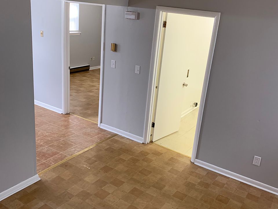View from living room. Door on right is to the bathroom. Door on left is to the bedroom. Opening to left is the kitchen.