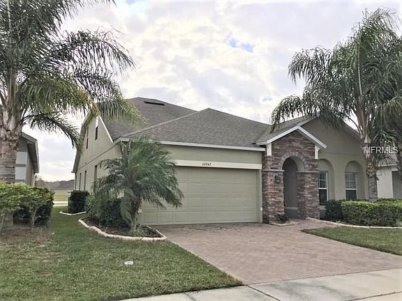 Left exterior view with lakefront showing in back yard!