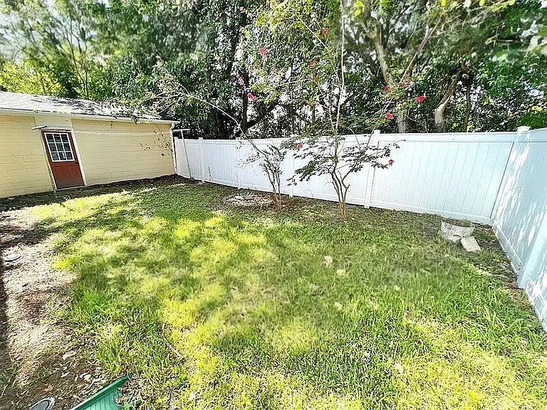 Backyard with detached garage for extra parking or storage