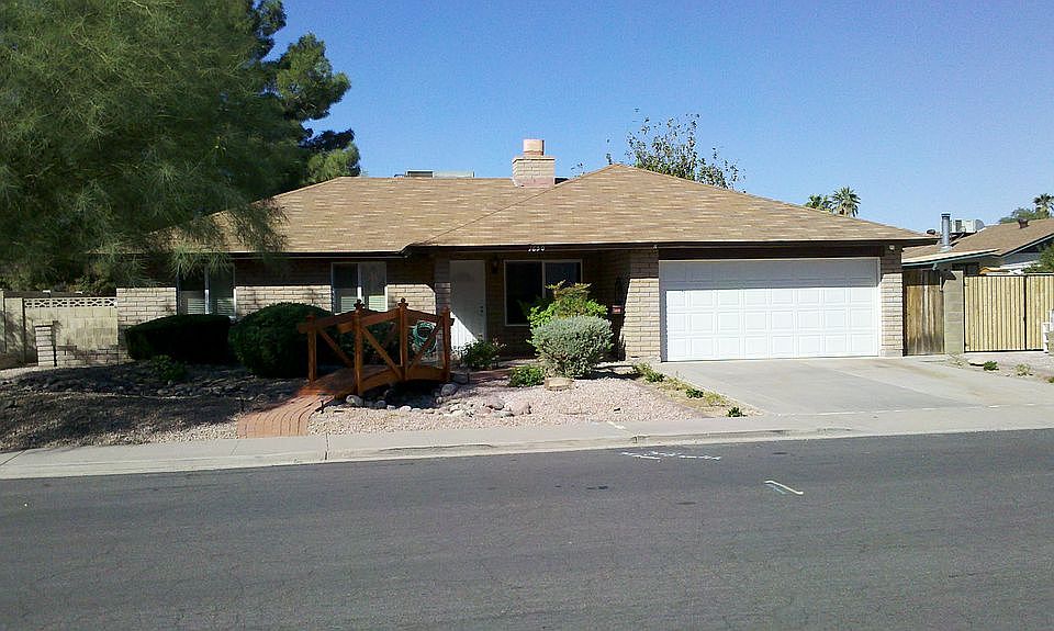 The front of the home, with redwood footbridge.