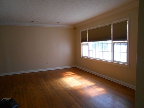 Living room has hardwood floors, natural light