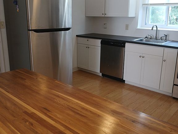 Stainless fridge Walnut Top Ceiling fan Shaker Cabinets