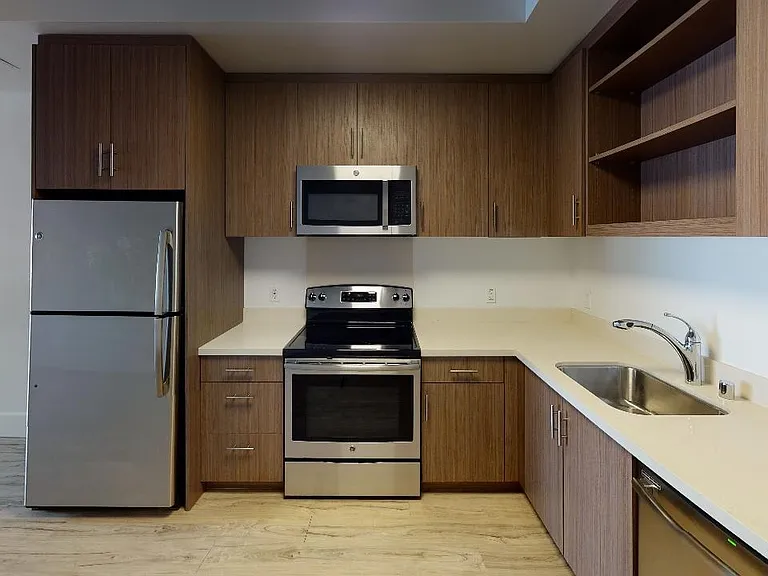 Stylish kitchen with stainless steel appliances and quartz countertops
