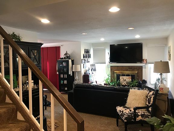 Gas fireplace. Extra lighting installed. An abundance of natural lighting in this townhome. Custom shades in every room.