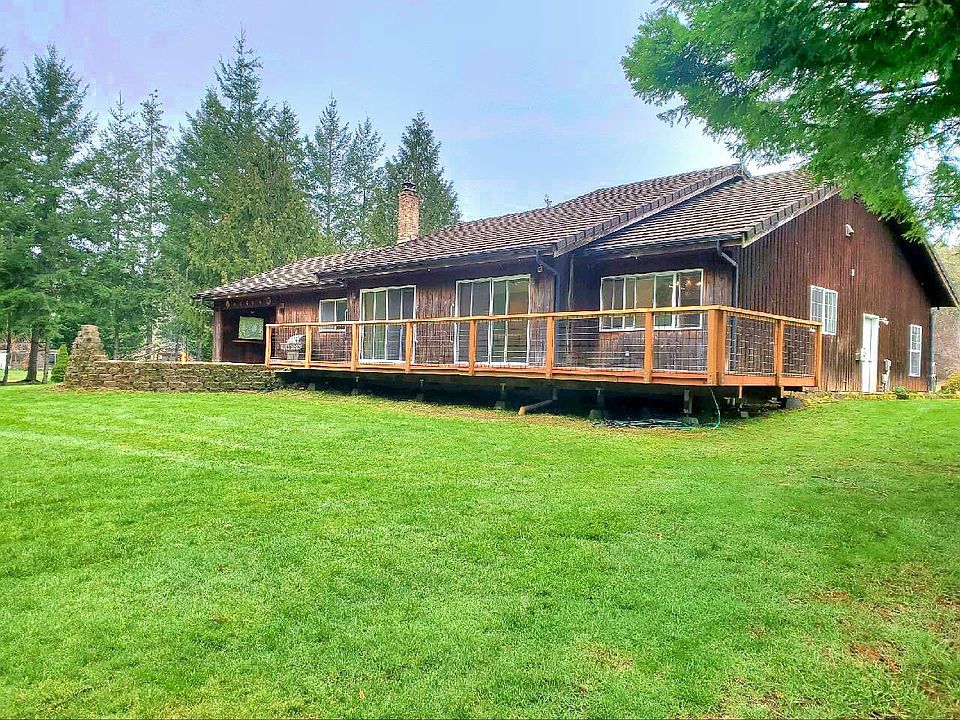 Deck on back. Two sliders in Living Room and one slider in Primary Bedroom open to this deck overlooking a vast greenspace, trees, and the Salish Sea.