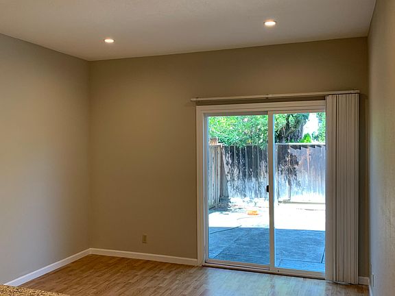 hard wood floor in family room, double sliding patio door lead to a low maintenance backyard