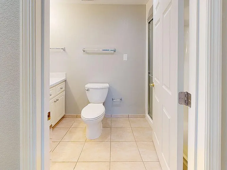 Bright and modern bathroom with sleek fixtures, tile flooring, and soft neutral tones offering a serene atmosphere.